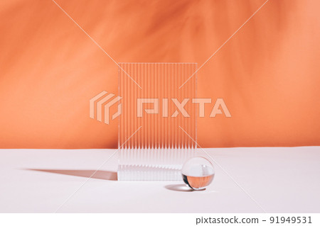 Abstract podium various geometric shapes made of glass, coral empty background, hard shadows plant Abstract podium various geometric shapes made of glass, coral empty background, hard shadows plant 91949531