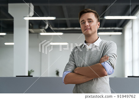Portrait of a handsome young man professional with arms crossed looking at camera in the IT company office 91949762