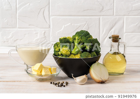 Cream of broccoli soup raw ingredients on the countertop. Puree soup recipe of broccoli florets. Cream of broccoli soup raw ingredients on the countertop. Puree soup recipe of broccoli florets. 91949976