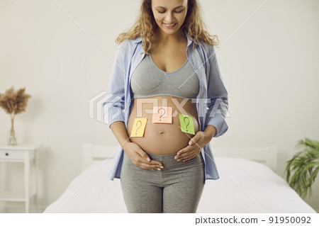 Happy pregnant woman wonder about baby gender 91950092