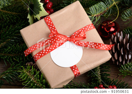Blank round Christmas gift tag mockup with present box, product label mockup, with natural fir tree branch Blank round Christmas gift tag mockup with present box, product label mockup, with natural fir tree branch 91950631