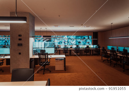 Empty interior of big modern security system control room, workstation with multiple displays, monitoring room with at security data center Empty office, desk, and chairs at a main CCTV security data Empty interior of big modern security system control room, workstation with multiple displays, monitoring room with at security data center Empty office, desk, and chairs at a main CCTV security data 91951055
