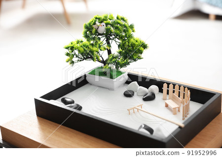Beautiful miniature zen garden on wooden table indoors Beautiful miniature zen garden on wooden table indoors 91952996