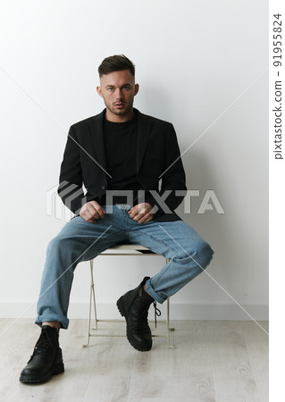 Modelling snapshots. Serious narcissistic self-confident attractive handsome man in classic suit sit on chair posing isolated in white studio background. Fashion offer. Copy space for ad Modelling snapshots. Serious narcissistic self-confident attractive handsome man in classic suit sit on chair posing isolated in white studio background. Fashion offer. Copy space for ad 91955824