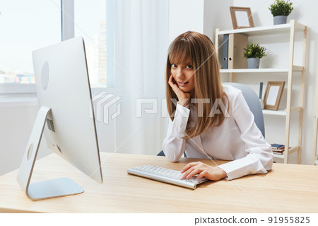 Happy smiling adorable blonde businesswoman typing answer for client look at camera sitting at workplace in modern office. Cheerful employee work on computer online in support service. Copy space Happy smiling adorable blonde businesswoman typing answer for client look at camera sitting at workplace in modern office. Cheerful employee work on computer online in support service. Copy space 91955825