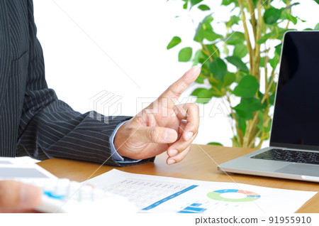 A man explaining at a table with materials A man explaining at a table with materials 91955910