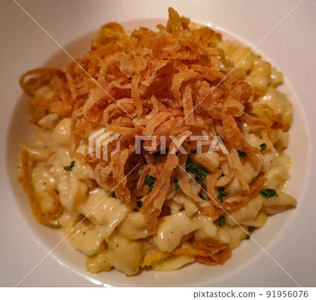 homemade South German pasta, baked with cheese, onions and garlic 91956076