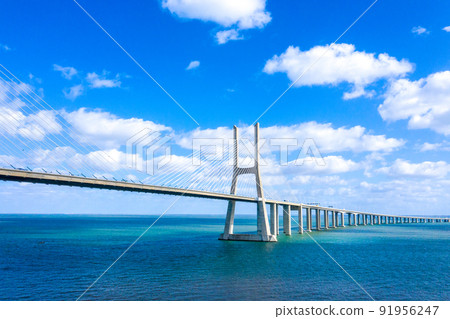 Famous Vasco da Gama Bridge over River Tejo in Lisbon from above 91956247