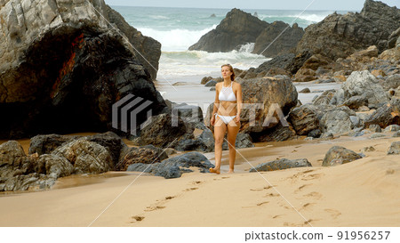 Young and sexy woman at the beach Young and sexy woman at the beach 91956257