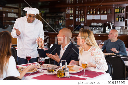 Upset couple complaining to chef about pizza quality 91957595