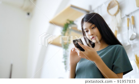 Happy young asian woman relaxing at home Happy young asian woman relaxing at home 91957835