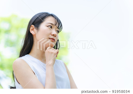 A Japanese woman who is troubled in the fresh green A Japanese woman who is troubled in the fresh green 91958034