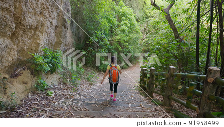 woman walk on mountain stairs woman walk on mountain stairs 91958499