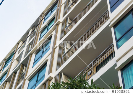Modern real estate condominium building with blue window 91958861