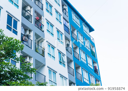 Modern real estate condominium building with blue window Modern real estate condominium building with blue window 91958874