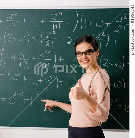 The female teacher standing in front of chalkboard The female teacher standing in front of chalkboard 91959143