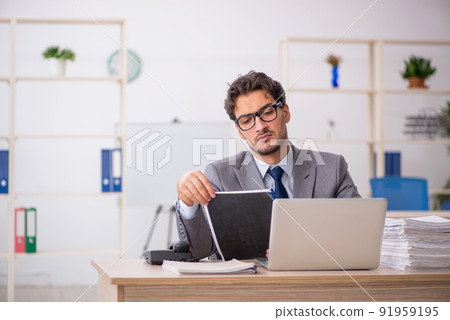 Young male employee sitting at workplace 91959195