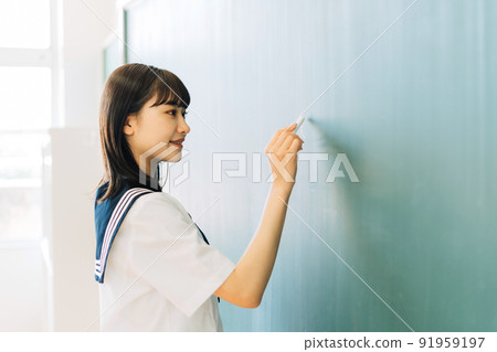 High school student writing letters on the blackboard 91959197
