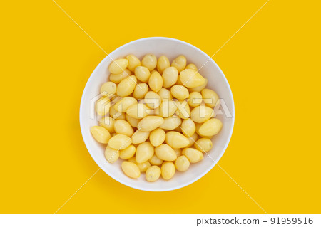 Boiled ginkgo nuts on yellow background. Boiled ginkgo nuts on yellow background. 91959516