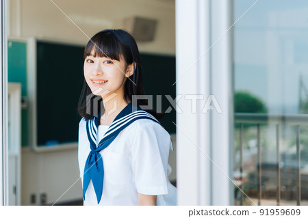 High school girl looking out from the classroom window 91959609