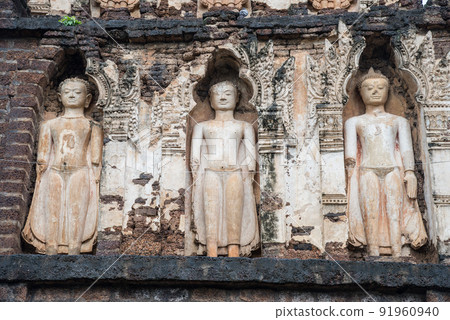 The Buddha statue decoration around ancient pagoda in Hariphunchai period located in Wat Cham Dhevi temple in Lamphun the northern province of Thailand. The Buddha statue decoration around ancient pagoda in Hariphunchai period located in Wat Cham Dhevi temple in Lamphun the northern province of Thailand. 91960940