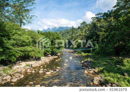 Scenery view of fresh water flows through the Kiriwong village the purest air and the best atmosphere in Thailand. Scenery view of fresh water flows through the Kiriwong village the purest air and the best atmosphere in Thailand. 91961079
