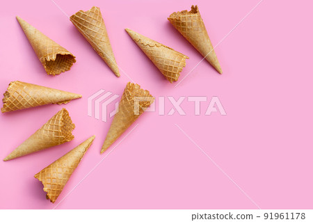 Empty ice cream cone on pink background. Empty ice cream cone on pink background. 91961178