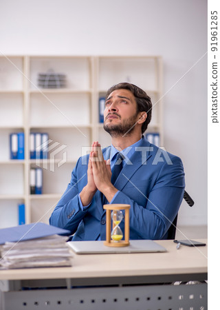 Young male employee in wheel-chair in time management concept Young male employee in wheel-chair in time management concept 91961285
