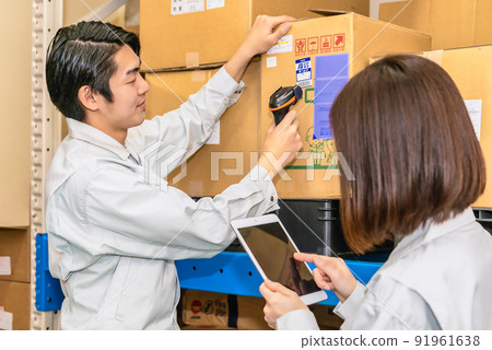 Workers checking inventory in the warehouse Workers checking inventory in the warehouse 91961638