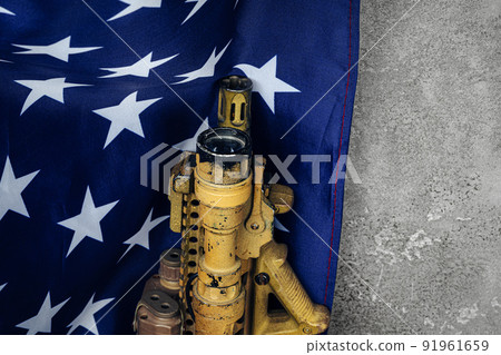 U.S. battle flag and assault rifle near the wall. close up. U.S. battle flag and assault rifle near the wall. close up. 91961659