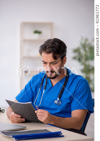 Young male doctor working in the clinic Young male doctor working in the clinic 91961772