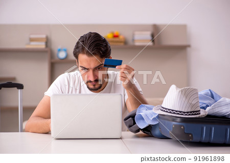 Young man preparing for trip at home 91961898