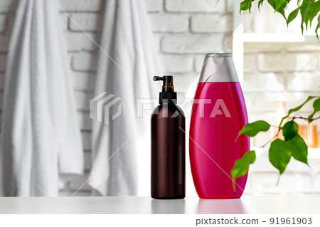 Cosmetic bottles against white bathroom wall background 91961903