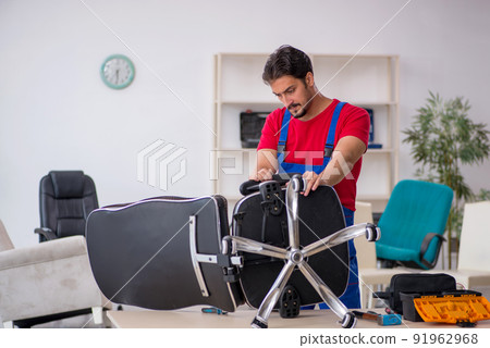Young male repairman working at workshop Young male repairman working at workshop 91962968