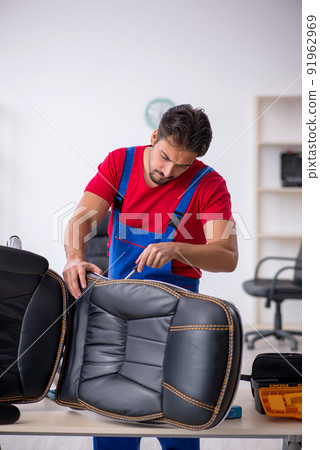 Young male repairman working at workshop Young male repairman working at workshop 91962969
