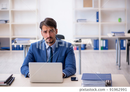 Young male employee working in the office Young male employee working in the office 91962991