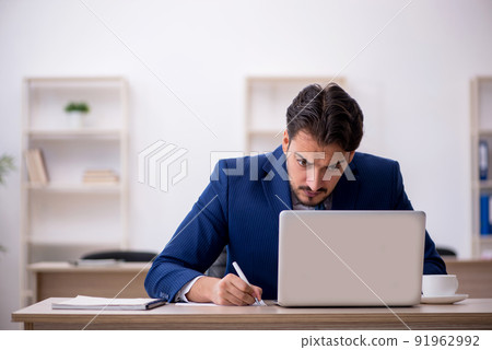 Young male employee working in the office Young male employee working in the office 91962992