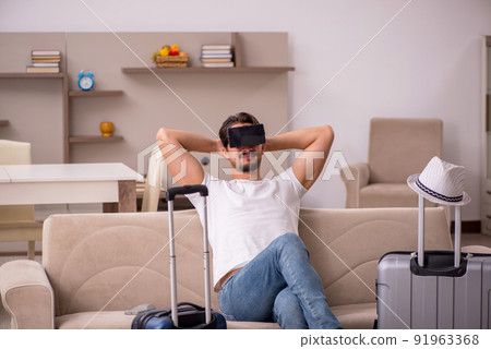 Young man preparing for trip at home Young man preparing for trip at home 91963368