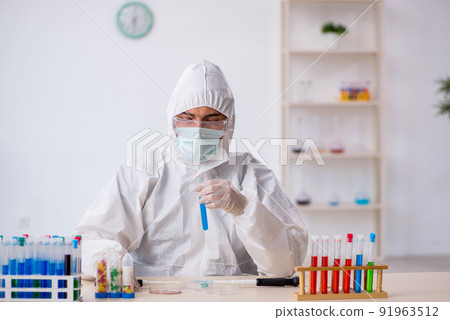 Young male chemist in drugs synthesis concept Young male chemist in drugs synthesis concept 91963512