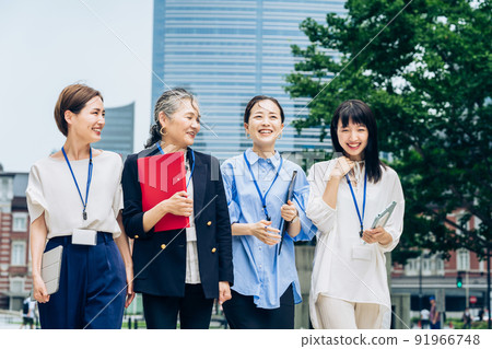 Business women of various ages walking in the business district Business women of various ages walking in the business district 91966748