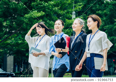 Business women of various ages walking in the business district Business women of various ages walking in the business district 91966753