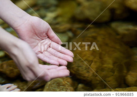 A woman's hand to save the water of the river A woman's hand to save the water of the river 91966885