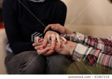Life partners holding hands at couple therapy session with counseling specialist, enjoying reconciliation after marriage issues. Solving relationship problems with professional help. Close up. Life partners holding hands at couple therapy session with counseling specialist, enjoying reconciliation after marriage issues. Solving relationship problems with professional help. Close up. 91967319