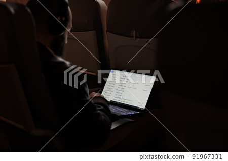 Male tourist flying with airplane and using laptop to browse on internet website during sunset flight. Man travelling in economy class to arrive at holiday destination, aerial transport. Male tourist flying with airplane and using laptop to browse on internet website during sunset flight. Man travelling in economy class to arrive at holiday destination, aerial transport. 91967331