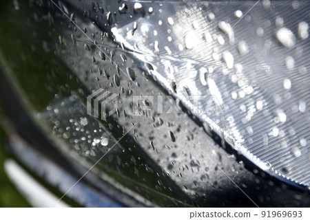 Water drops on the transparent surface of the car headlight Water drops on the transparent surface of the car headlight 91969693