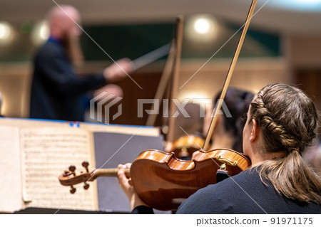 a violinist plays at a concert in the Philharmonic 91971175