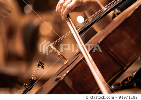 detail of the cello being played during the concert 91971182