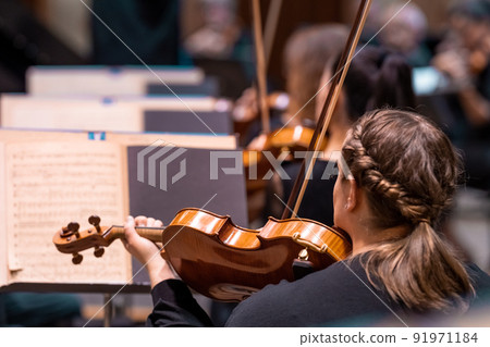a violinist plays at a concert in the Philharmonic a violinist plays at a concert in the Philharmonic 91971184