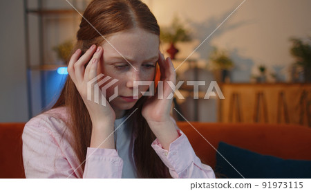 Close-up portrait of tired woman teacher suffering from tension, migaine headache at home office 91973115