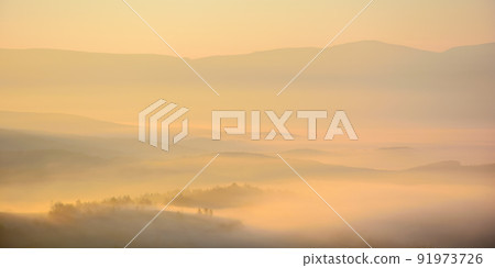 carpathian countryside scenery at sunrise. fog rolling among the hills down in to the rural valley in autumn. wonderful mountain landscape glowing in morning light 91973726